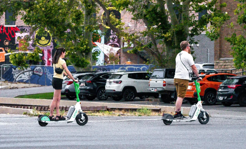 Couple riding scooters in SLC
